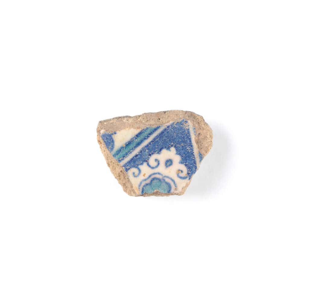 Tile fragment with border lines and a cloud motif